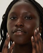 Person touching their cheeks and jawline